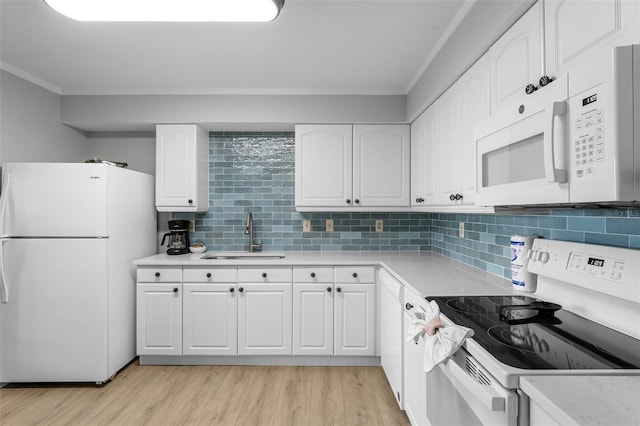 3655 Scenic Highway 98 Unit 503B, Destin, FL 32541 - kitchen featuring white appliances, a sink, light countertops, white cabinets, and tasteful backsplash