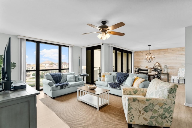 3655 Scenic Highway 98 Unit 503B, Destin, FL 32541 - living room with floor to ceiling windows, wood walls, a chandelier, light wood finished floors, and ceiling fan
