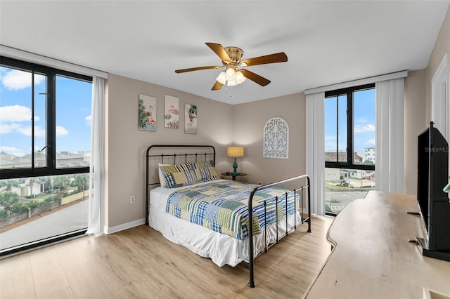 3655 Scenic Highway 98 Unit 503B, Destin, FL 32541 - bedroom with wood finished floors, a ceiling fan, access to outside, expansive windows, and baseboards