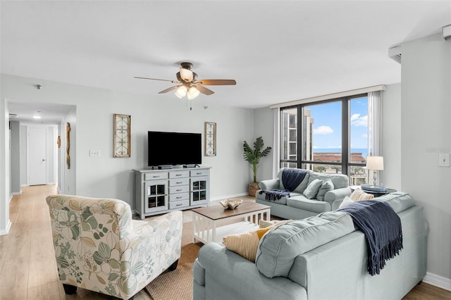 3655 Scenic Highway 98 Unit 503B, Destin, FL 32541 - living room with a ceiling fan, wood finished floors, and baseboards