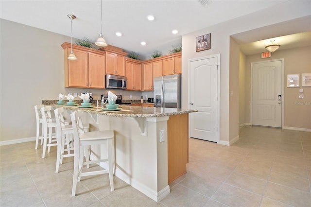 kitchen featuring pendant lighting, light tile patterned floors, stainless steel appliances, and kitchen peninsula