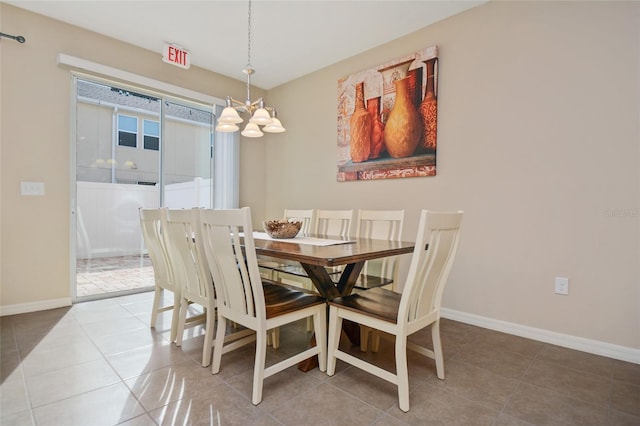 tiled dining space with a chandelier