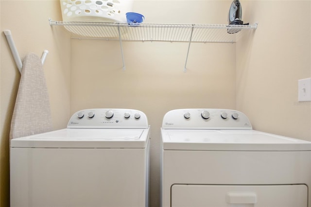 clothes washing area featuring independent washer and dryer