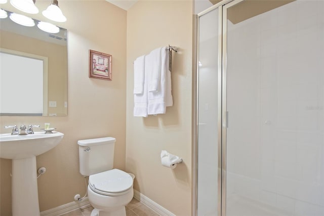 bathroom with a shower with shower door, sink, tile patterned floors, and toilet