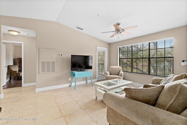 tiled living room with ceiling fan and vaulted ceiling