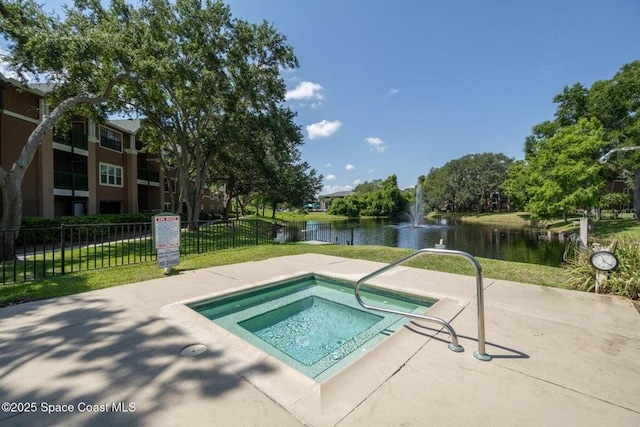 view of swimming pool with a hot tub and a water view