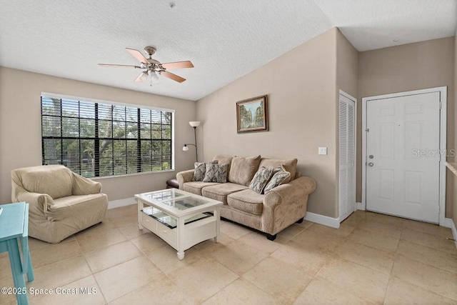 tiled living room with ceiling fan and a textured ceiling