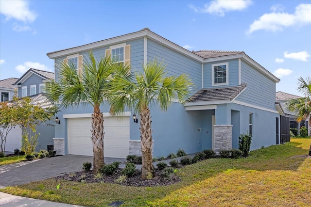 view of front facade with a garage and a front lawn