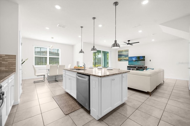 kitchen featuring white cabinetry, light stone counters, hanging light fixtures, dishwasher, and a kitchen island with sink