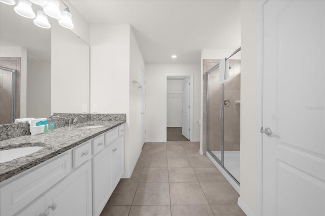 bathroom featuring vanity, an enclosed shower, and tile patterned flooring