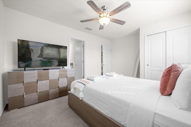 carpeted bedroom featuring ceiling fan and a closet