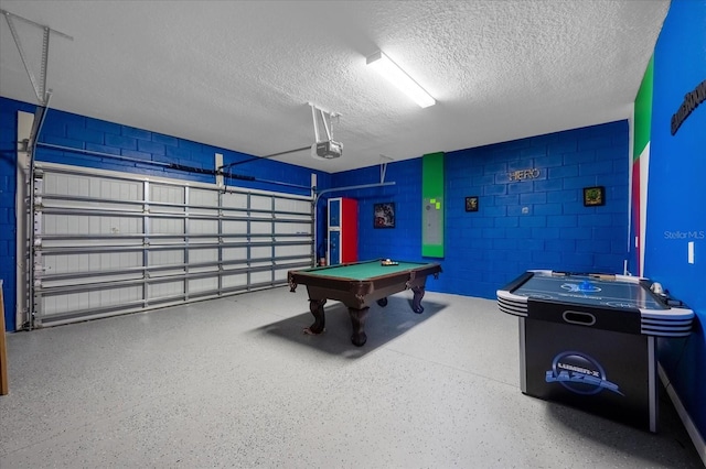 recreation room featuring a textured ceiling