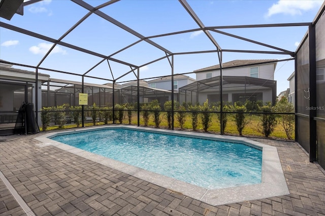 view of pool with a lanai and a patio area