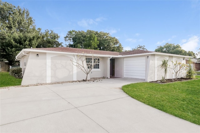 ranch-style home featuring a garage and a front yard