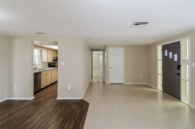 entryway with sink and light hardwood / wood-style floors