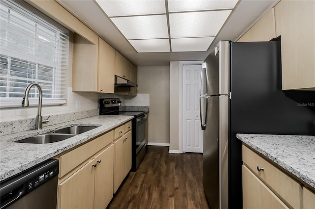 kitchen featuring appliances with stainless steel finishes, dark wood-type flooring, light brown cabinets, sink, and light stone counters