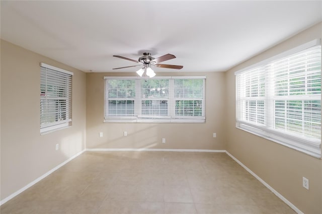 empty room featuring light tile patterned floors and ceiling fan