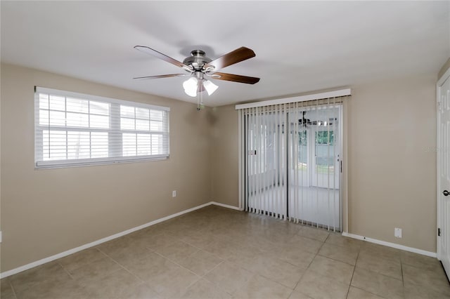 tiled empty room featuring ceiling fan