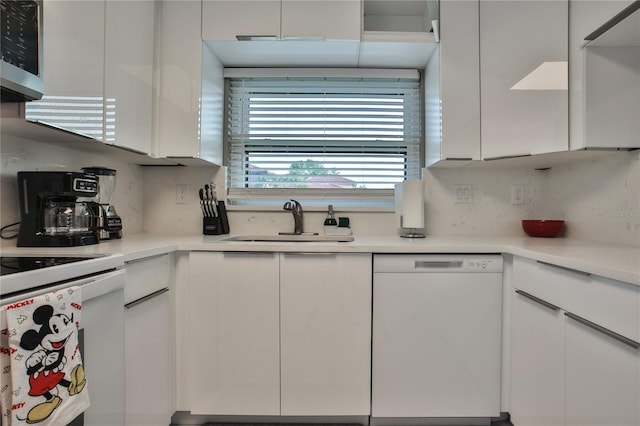 kitchen featuring white cabinetry, white appliances, sink, and tasteful backsplash