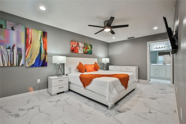 bedroom with connected bathroom, a textured ceiling, sink, and ceiling fan