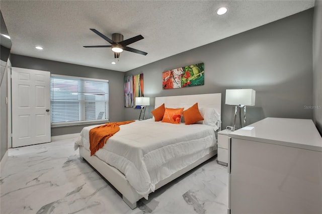 bedroom with ceiling fan, refrigerator, and a textured ceiling