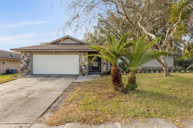 ranch-style house featuring a garage, central AC, and a front yard