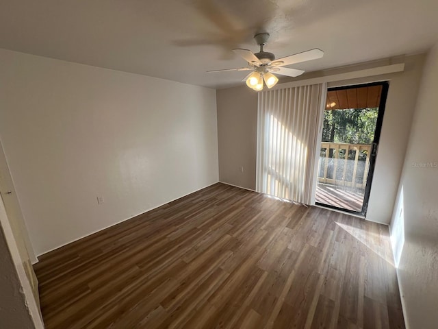 unfurnished room with ceiling fan and dark wood-type flooring