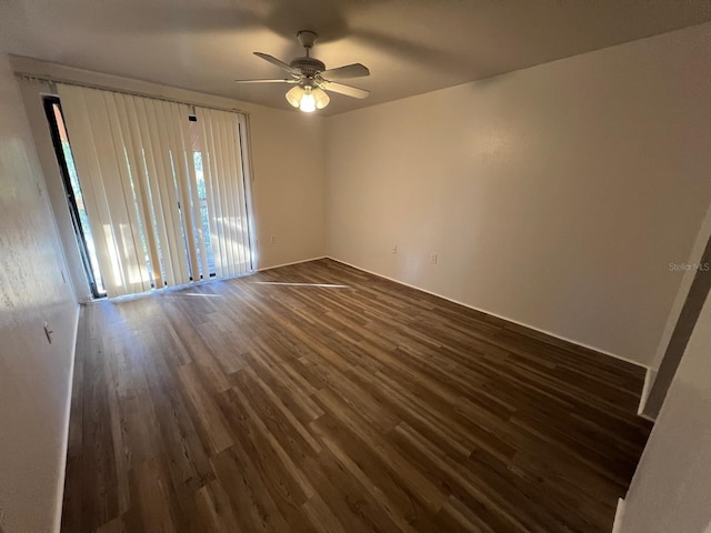 spare room with ceiling fan and dark hardwood / wood-style flooring