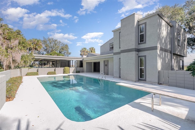 view of pool featuring a patio and a diving board