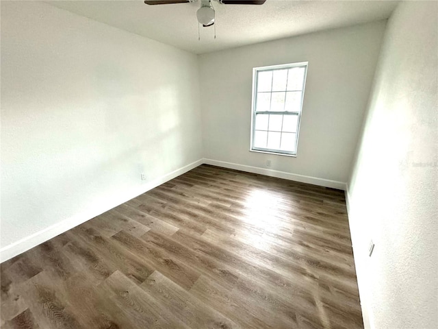 spare room with ceiling fan and dark hardwood / wood-style floors