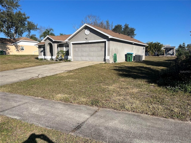 ranch-style house with central AC, a garage, and a front yard