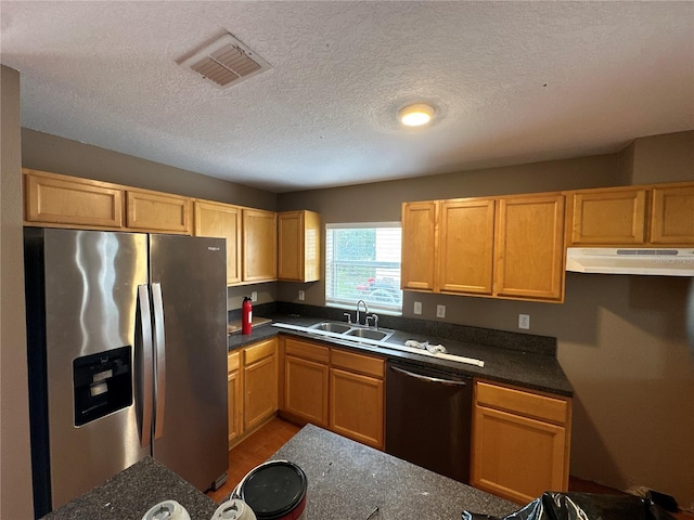 kitchen with stainless steel fridge, visible vents, dishwashing machine, under cabinet range hood, and a sink