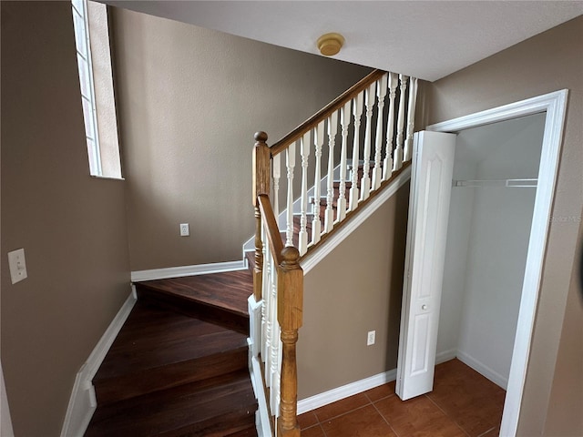 stairs featuring baseboards and tile patterned floors