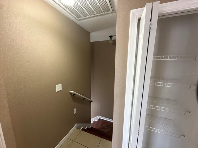 bathroom featuring tile patterned flooring, visible vents, and baseboards