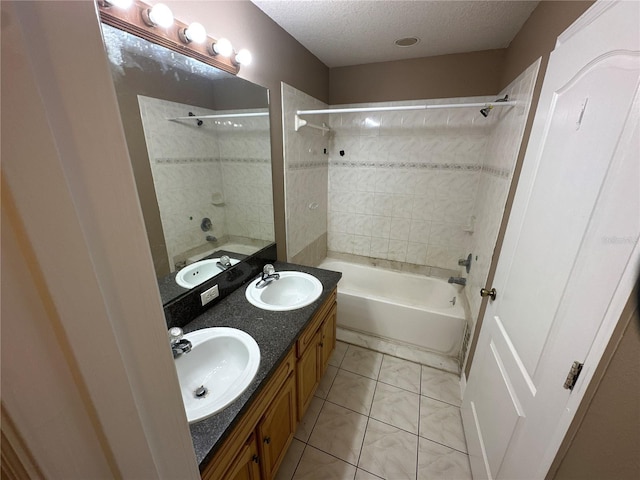 full bathroom featuring a textured ceiling, tub / shower combination, and a sink