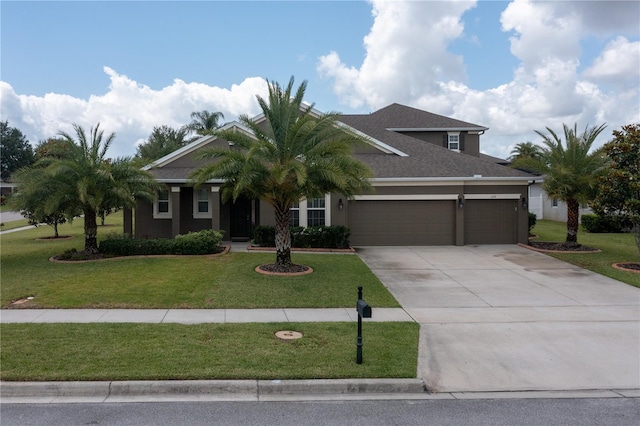 view of front of home with a garage and a front lawn