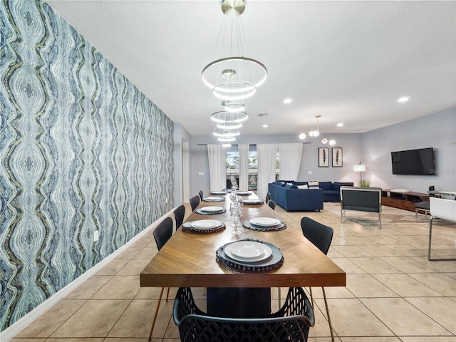 dining space featuring light tile patterned flooring and a notable chandelier