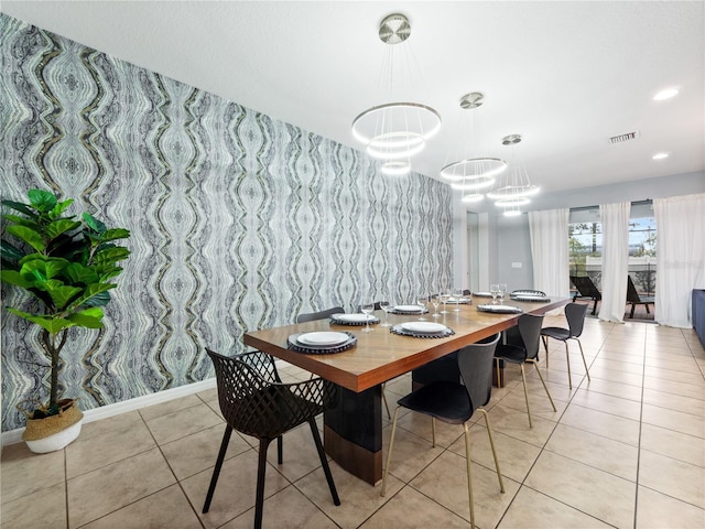 tiled dining room featuring a notable chandelier