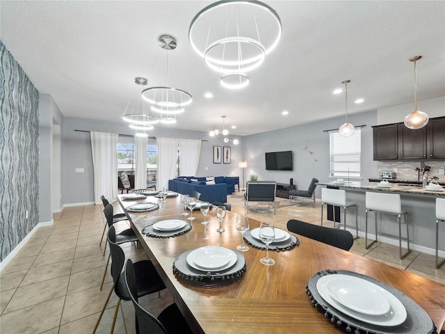 tiled dining space featuring a chandelier