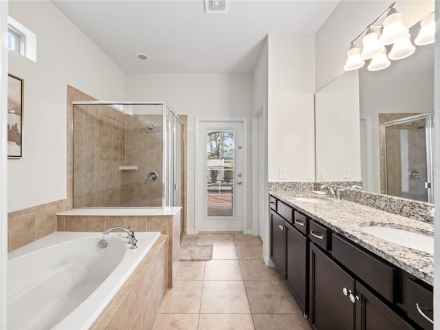 bathroom featuring vanity, shower with separate bathtub, and tile patterned flooring