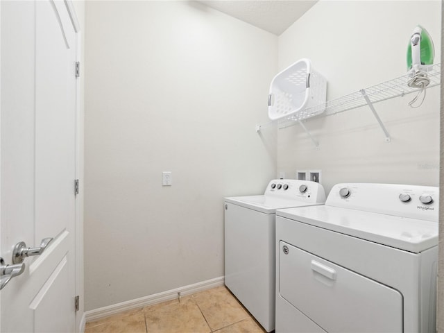 laundry room with light tile patterned flooring and separate washer and dryer