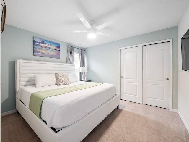 bedroom featuring ceiling fan, carpet, and a closet