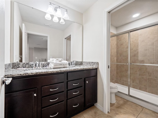 bathroom with an enclosed shower, vanity, tile patterned flooring, and toilet