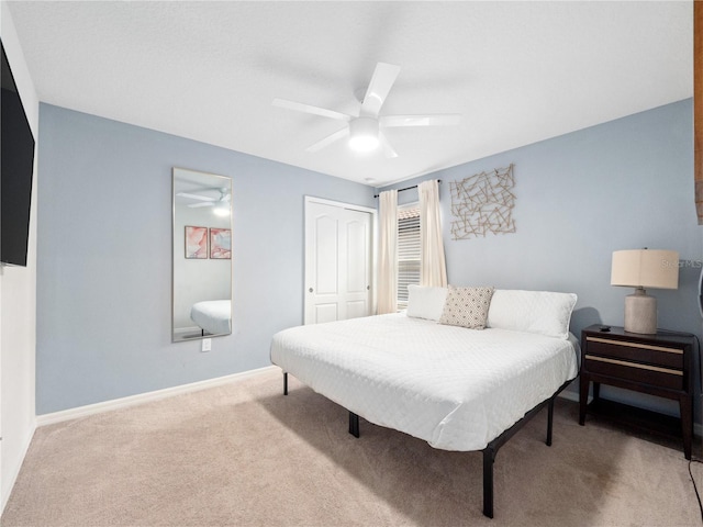 carpeted bedroom with a closet and ceiling fan