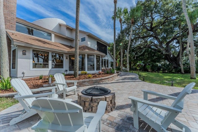 view of patio / terrace featuring an outdoor fire pit