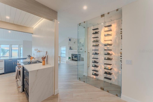 wine room featuring lofted ceiling with beams and wood ceiling