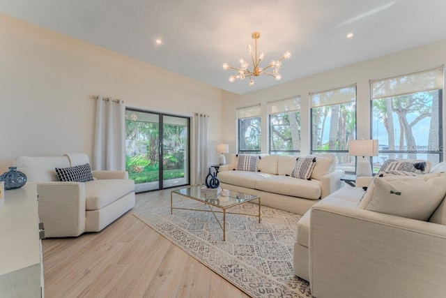 living room featuring an inviting chandelier and light wood-type flooring