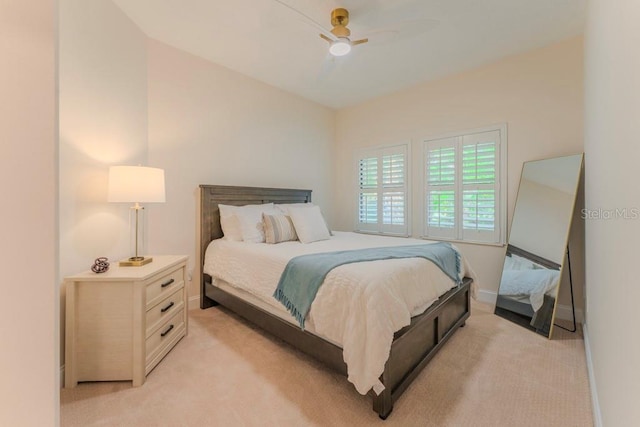 bedroom featuring ceiling fan and light colored carpet