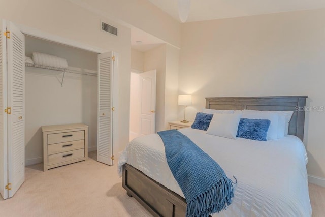 bedroom with light colored carpet and a closet