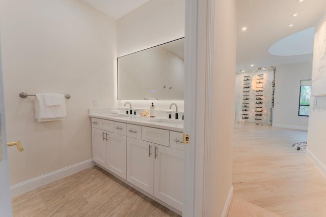 bathroom with vanity and wood-type flooring